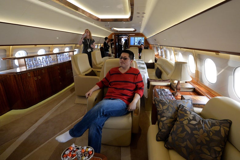 A man tries out the interior on an Airbus A319 private business jet during the Asian Business Aviation Conference and Exhibition (ABACE2014) at the Shanghai Hongqiao airport on April 14, 2014.